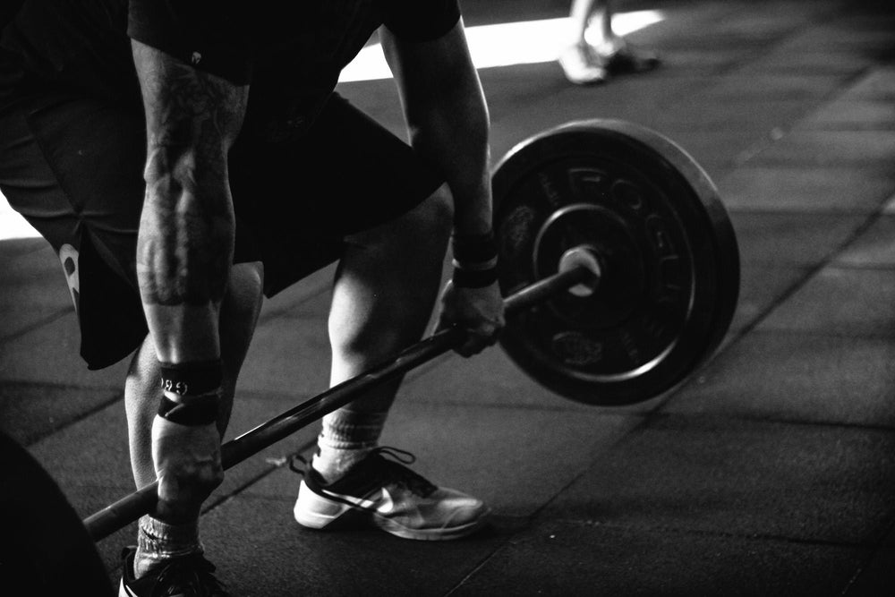 A man carrying a dumbbell representing good and strong muscles.