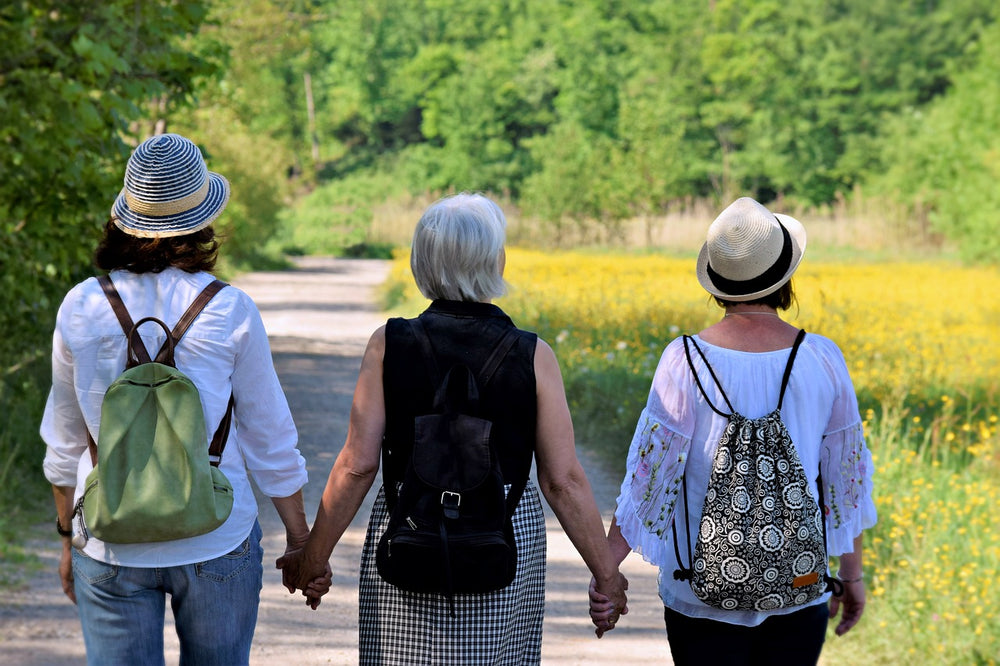 An image of women on their menopause period, holding hands.